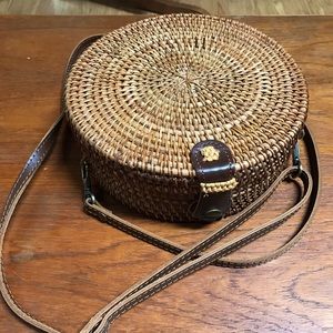 8” round woven straw rattan cross body bag.